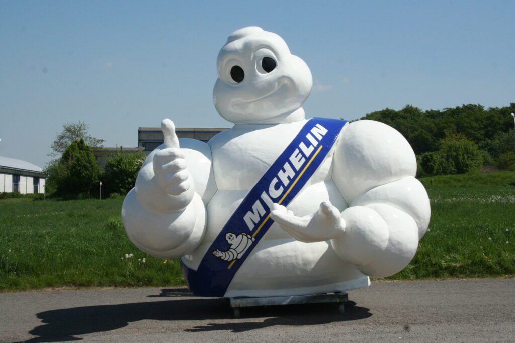 The giant plastic figure in front of a green meadow