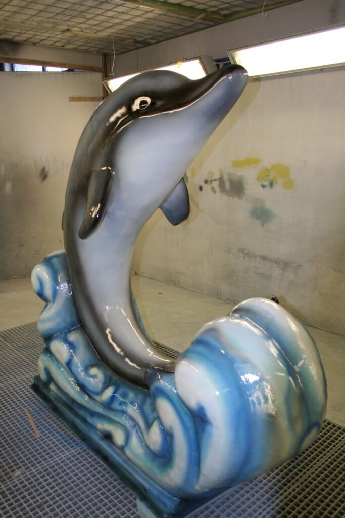 Airbrush painted plastic figure of a dolphin made of GRP