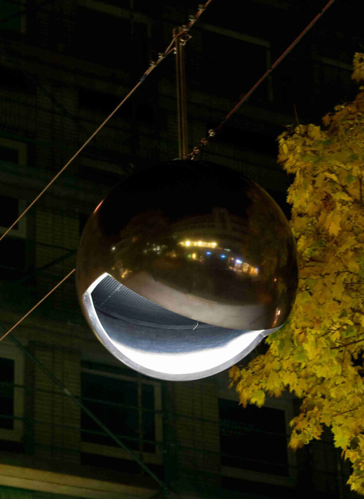 Illuminated mirrored globe light in the dark
